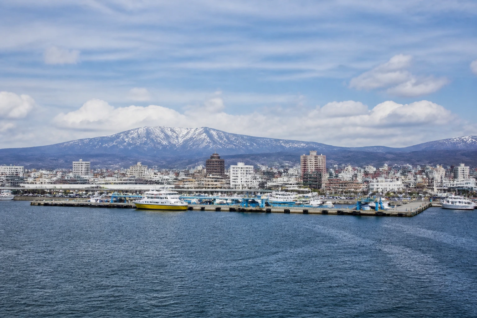Representative cruise port destination view: Aomori, Japan; passenger waterfront and harbor water, not an exact landmark photograph.