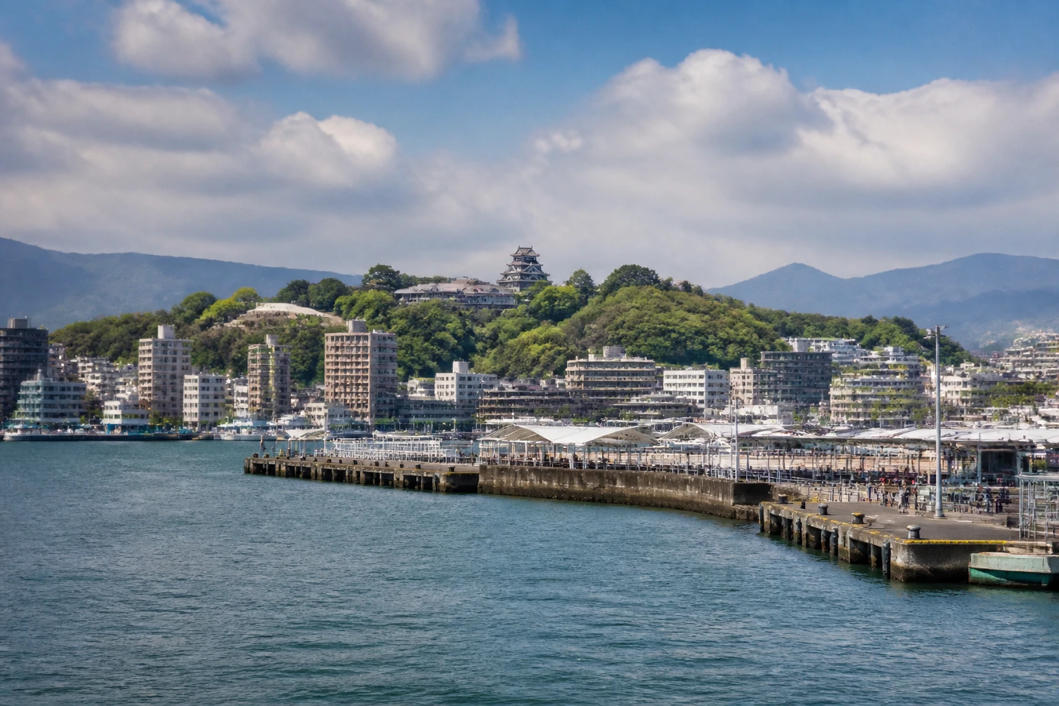 Representative cruise port destination view: Kumamoto, Japan; passenger waterfront and harbor water, not an exact landmark photograph.