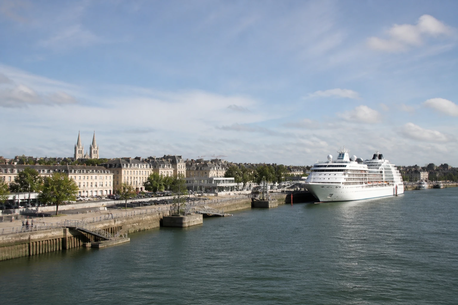 Representative cruise port destination view: Caen, France; passenger waterfront and harbor water, not an exact landmark photograph.