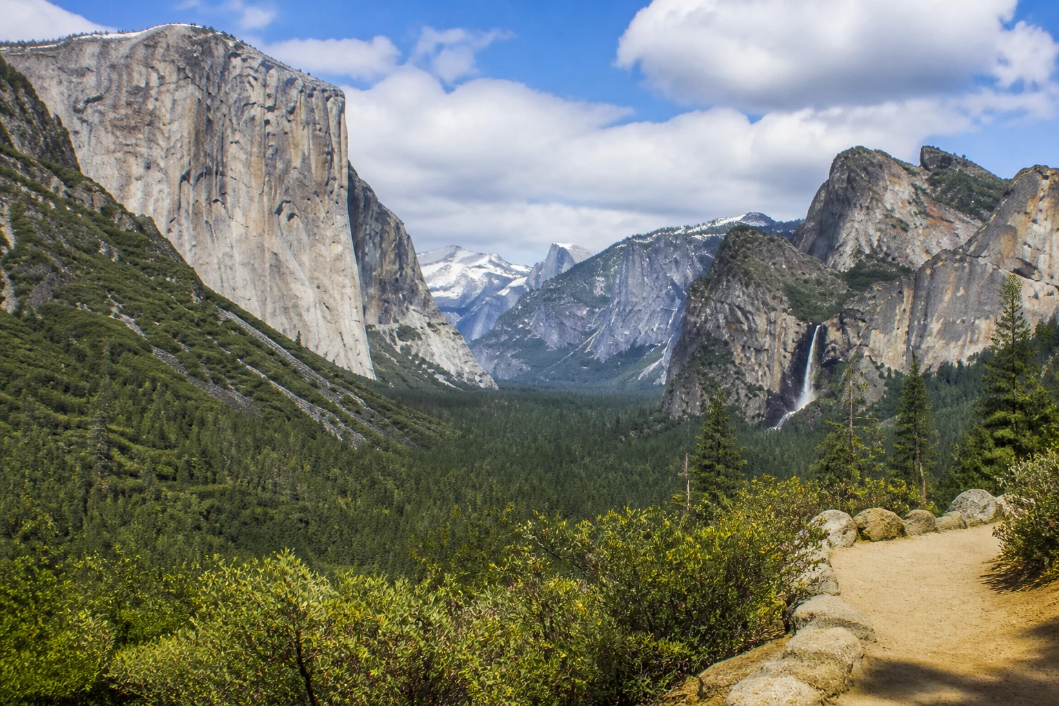 Representative national park destination view: Yosemite National Park, United States; protected terrain and native vegetation, not an exact landmark photograph.