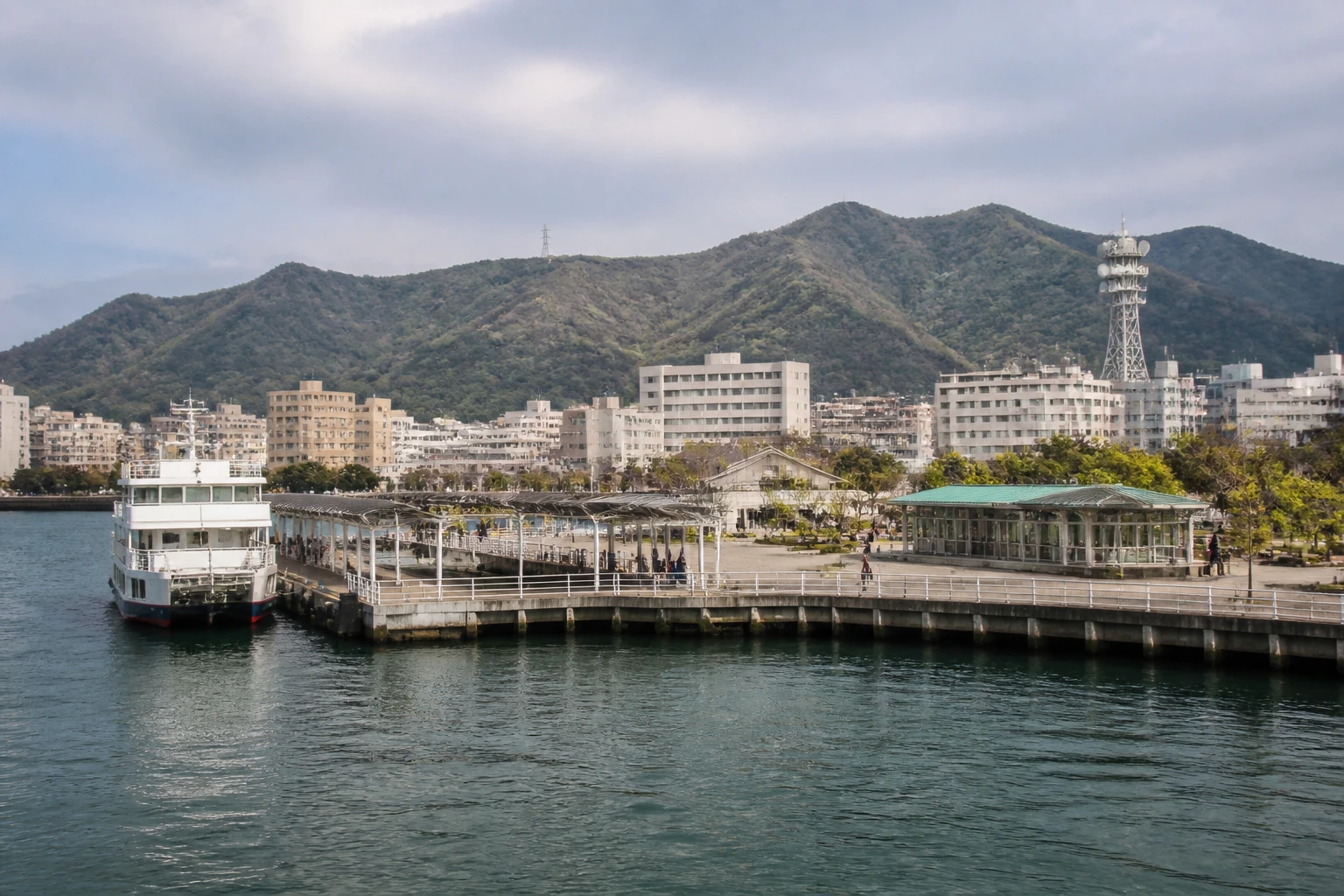 Representative cruise port destination view: Tokushima, Japan; passenger waterfront and harbor water, not an exact landmark photograph.