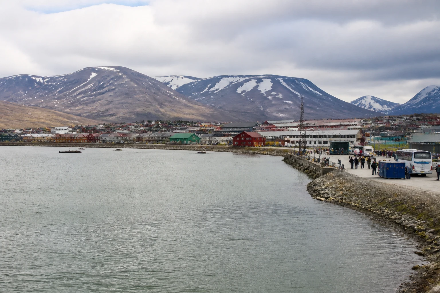 Representative cruise port destination view: Longyearbyen, Norway; passenger waterfront and harbor water, not an exact landmark photograph.