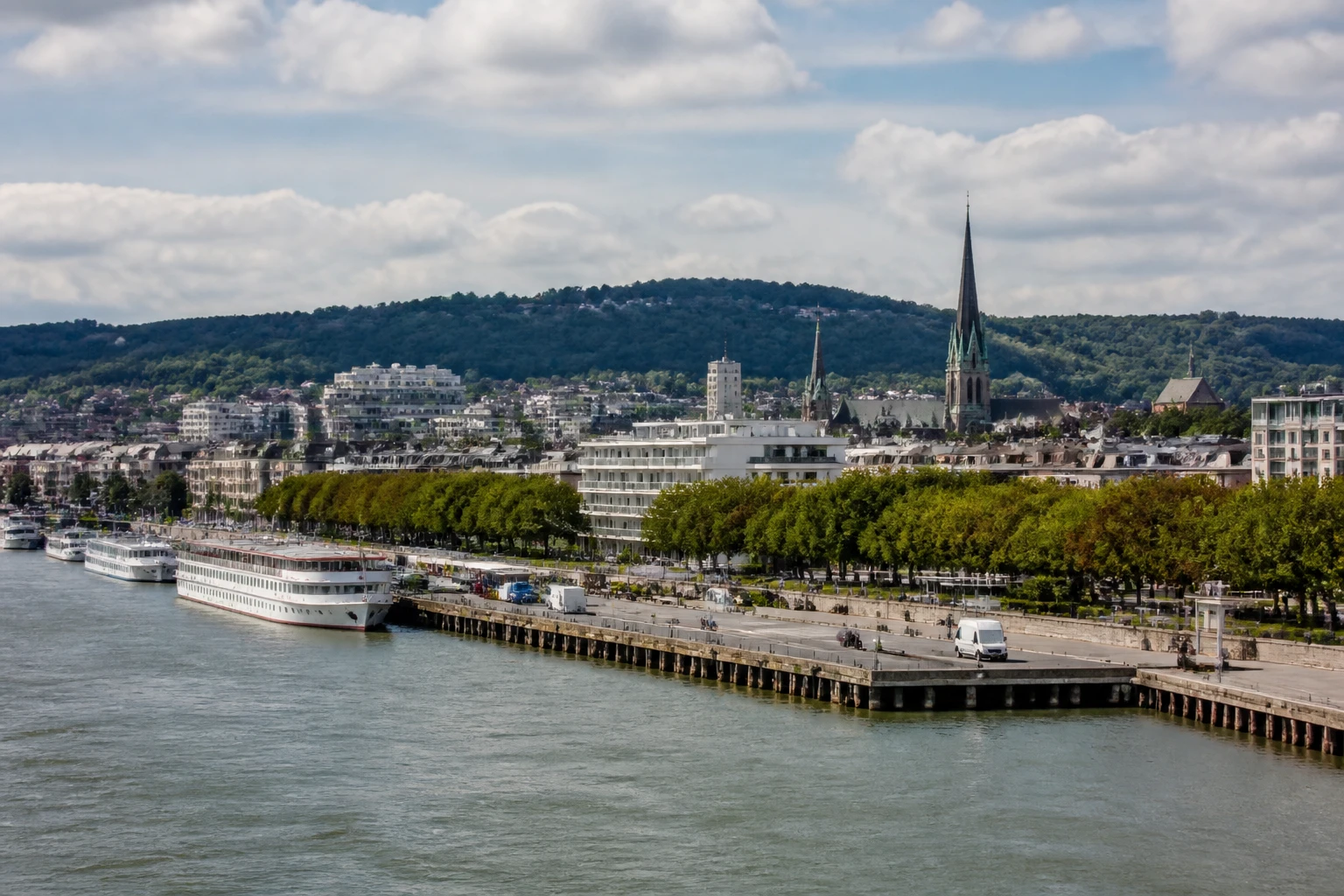 Representative cruise port destination view: Rouen, France; passenger waterfront and harbor water, not an exact landmark photograph.