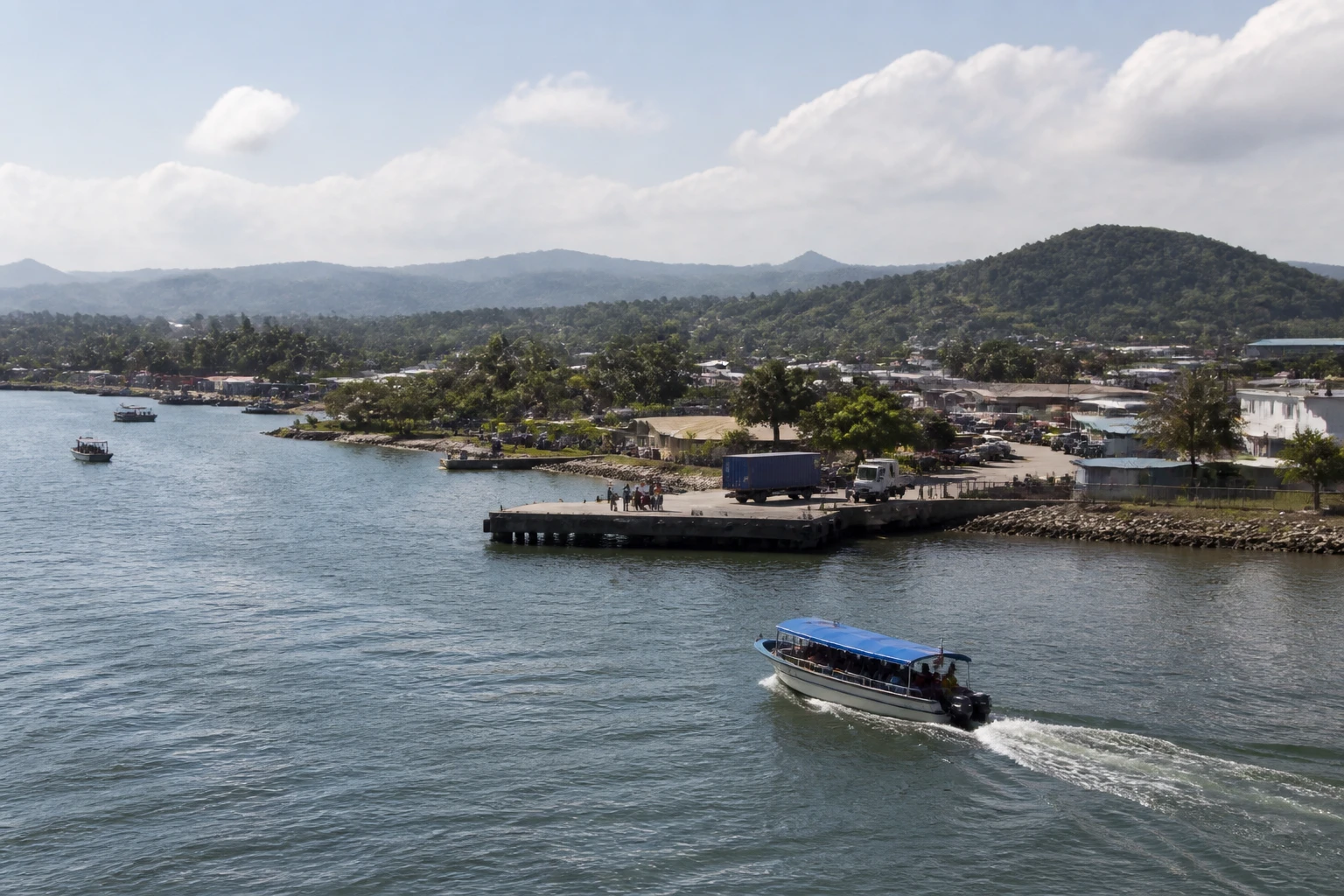 Representative cruise port destination view: Santo Tomas de Castilla, Guatemala; passenger waterfront and harbor water, not an exact landmark photograph.