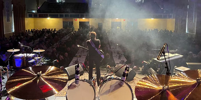 A musician performing before an audience in a lively Greenville, Mississippi, music venue.