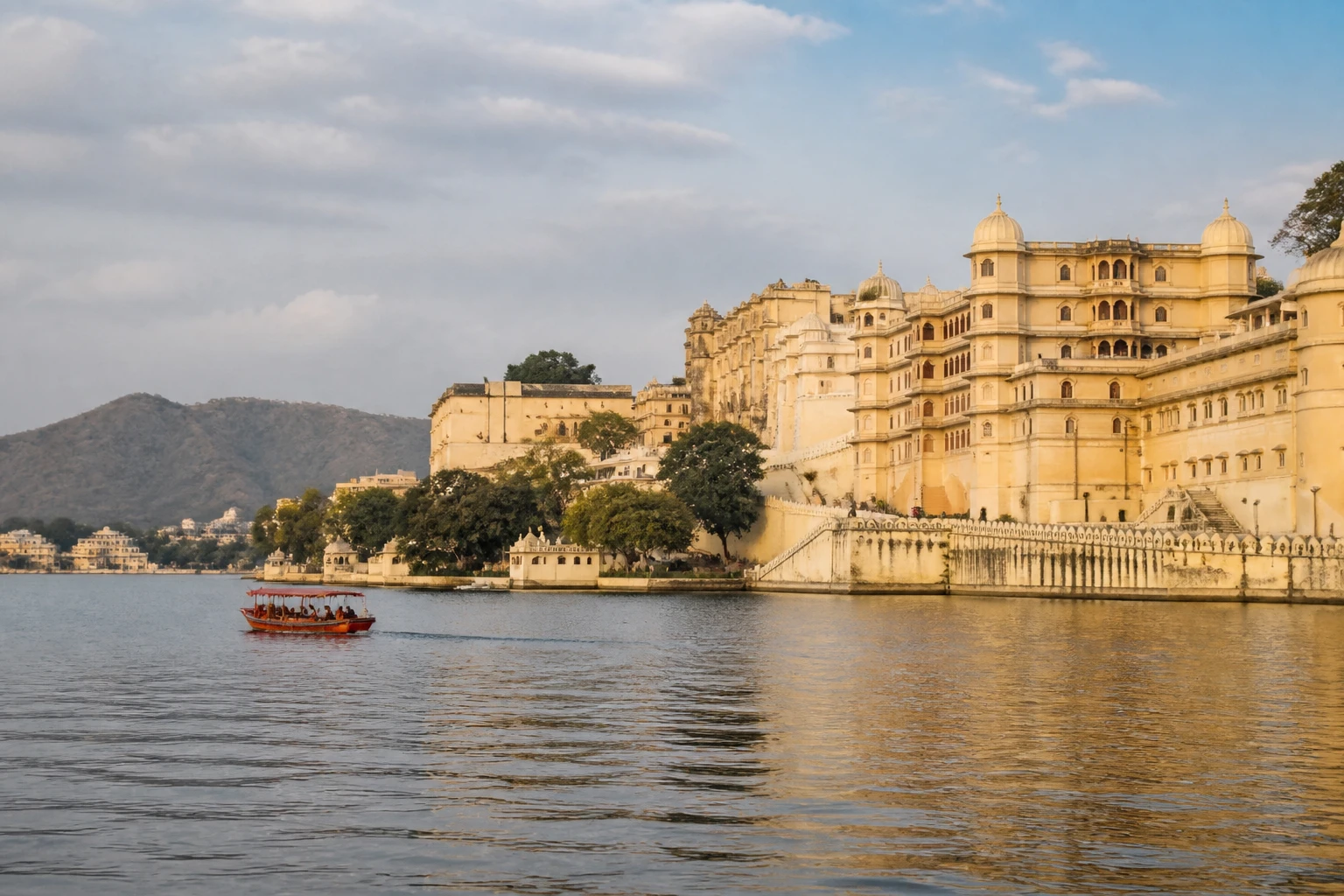 Representative lake destination view of Udaipur in India, with inland water, regional terrain, vegetation, and natural light; not an exact landmark photograph.