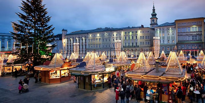 Illuminated holiday decorations and Christmas market stalls in Historic Linz at Christmas.