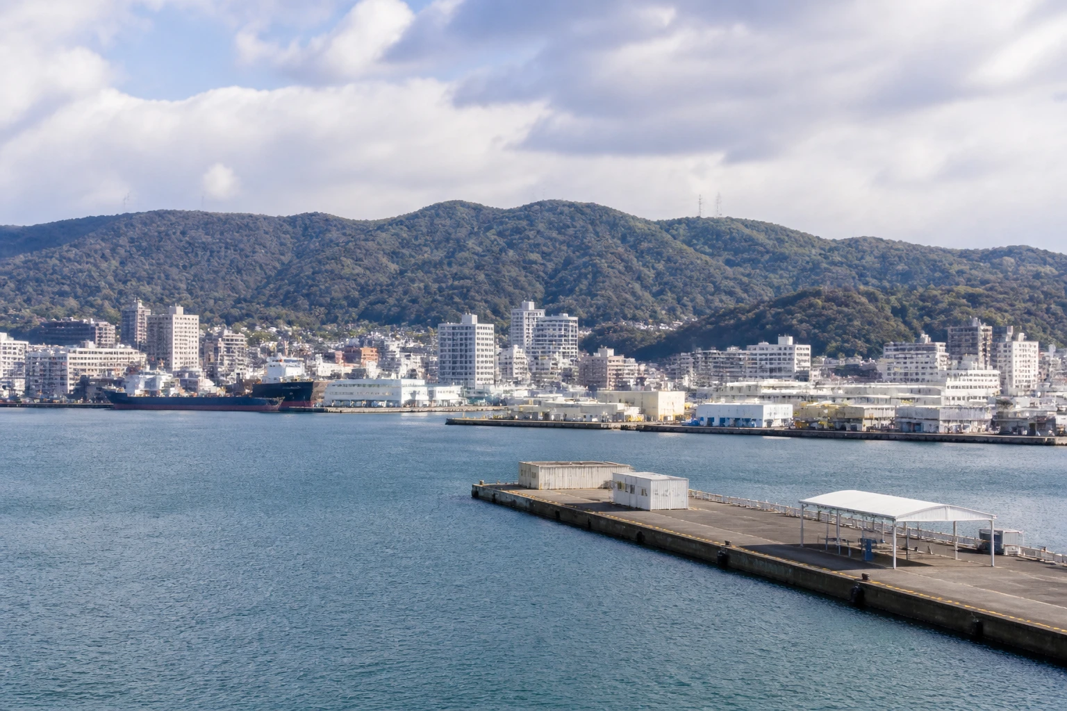 Representative cruise port destination view: Wakayama, Japan; passenger waterfront and harbor water, not an exact landmark photograph.