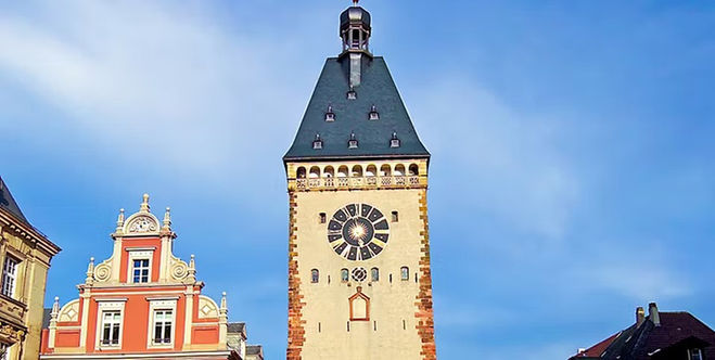 Historic towers rising above the surrounding city architecture in Speyer, Germany.