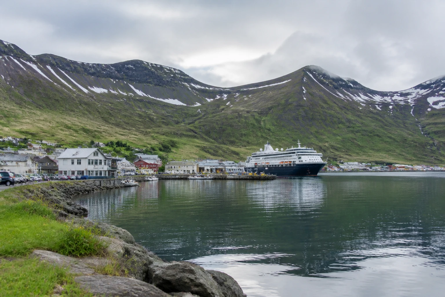 Representative cruise port destination view: Siglufjörður, Iceland; passenger waterfront and harbor water, not an exact landmark photograph.