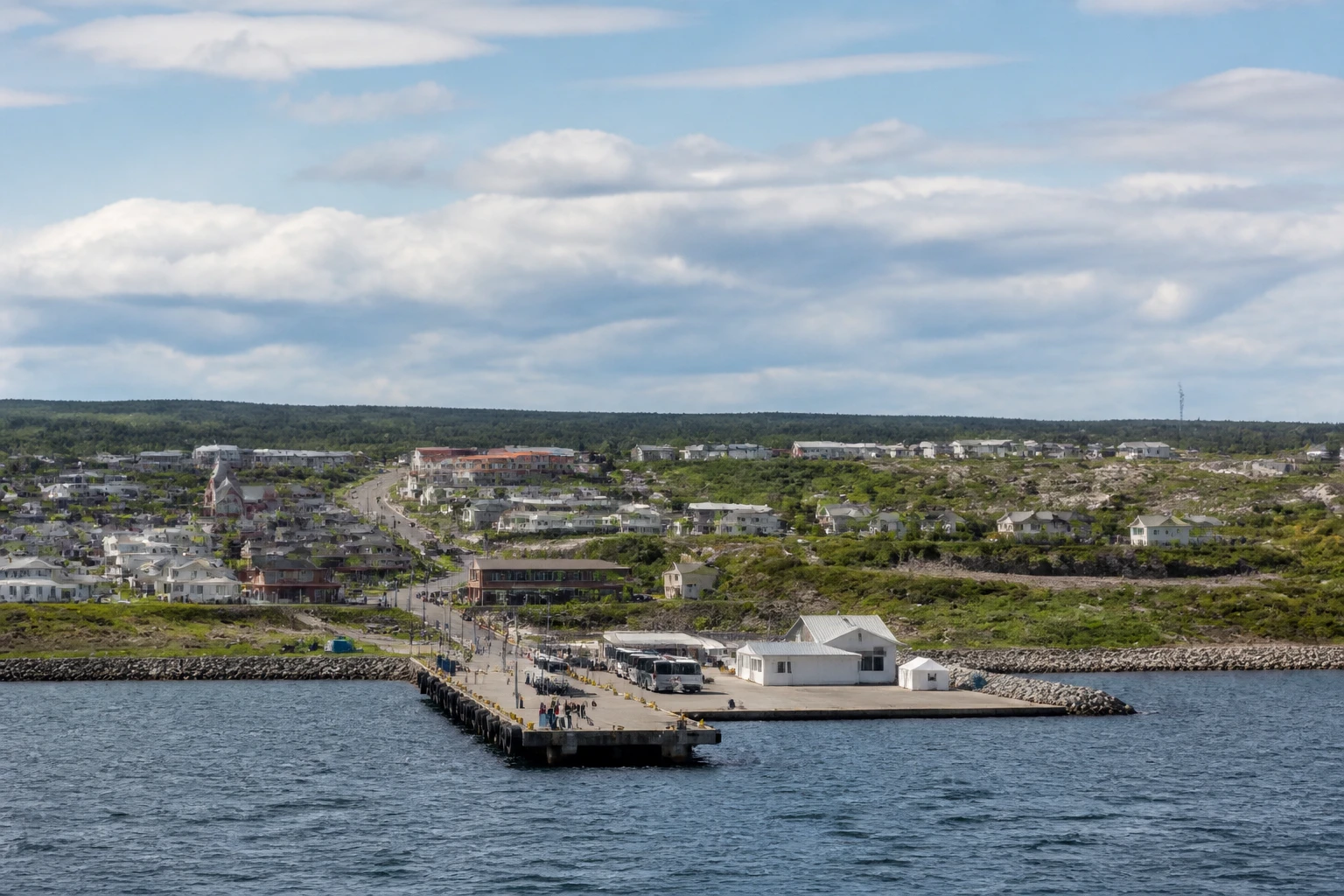 Representative cruise port destination view: Havre-Saint-Pierre, Canada; passenger waterfront and harbor water, not an exact landmark photograph.