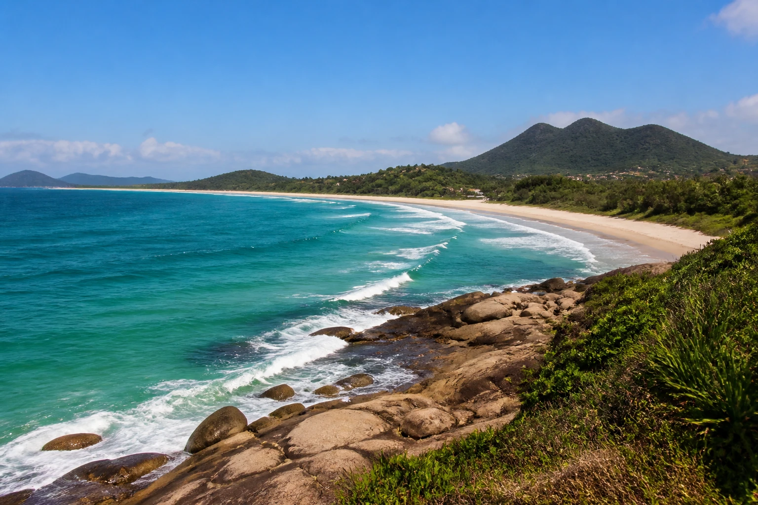 Representative island destination view: Florianopolis, Brazil; coastline and regional vegetation, not an exact landmark photograph.