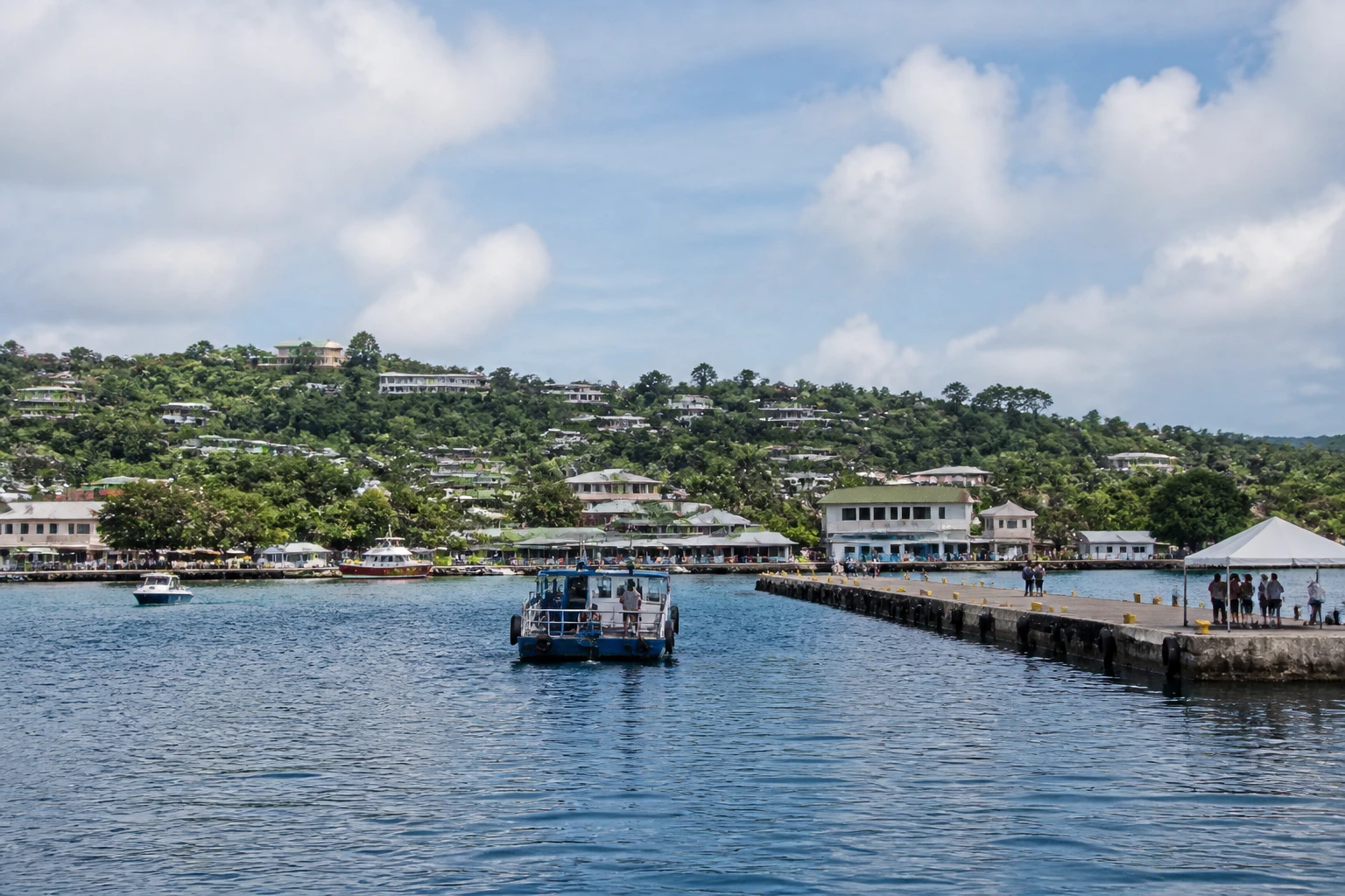 Representative cruise port destination view: Santo, Vanuatu; passenger waterfront and harbor water, not an exact landmark photograph.