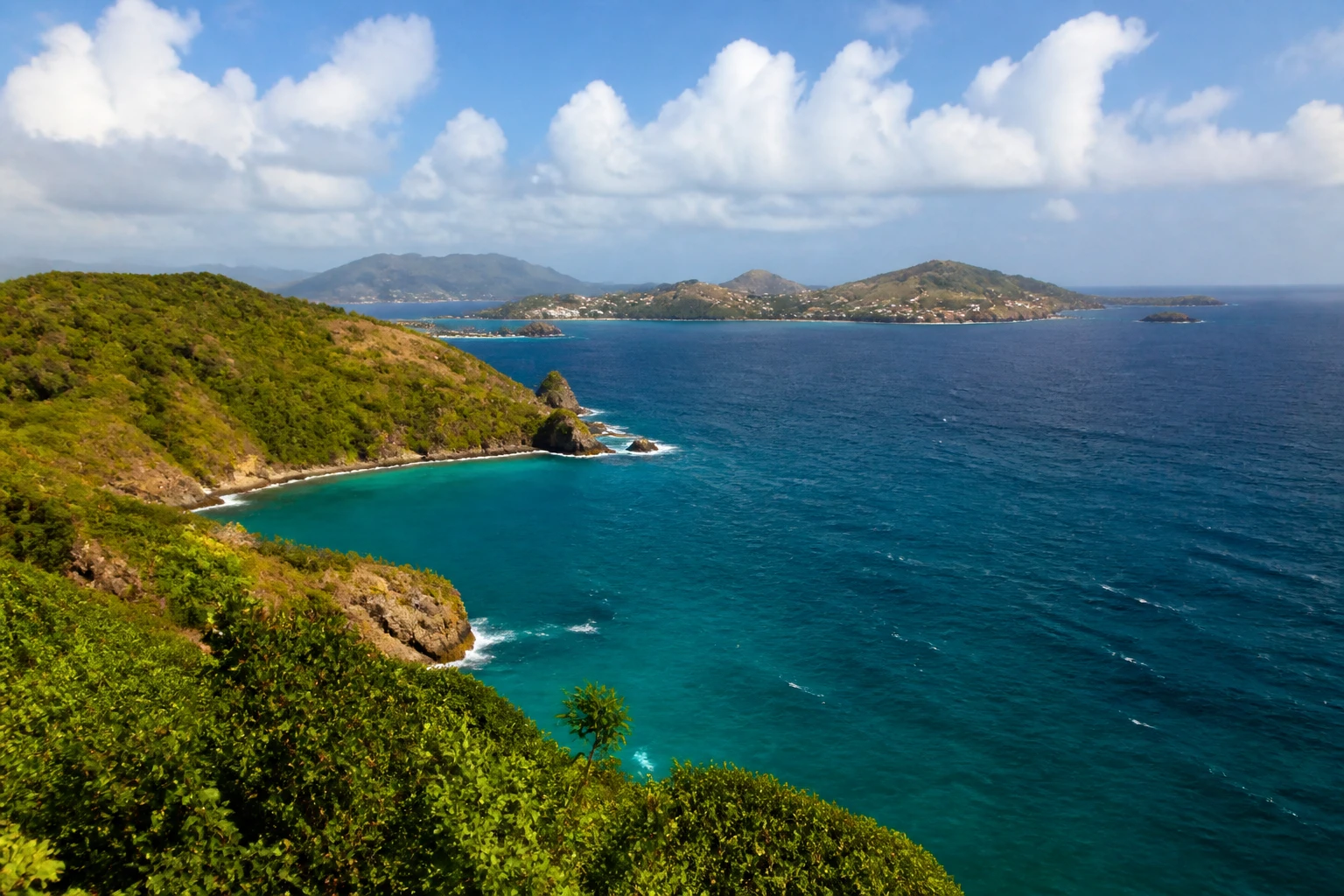 Representative island destination view of Grenada, with coastline, shoreline geology, regional vegetation, and natural light; not an exact landmark photograph.