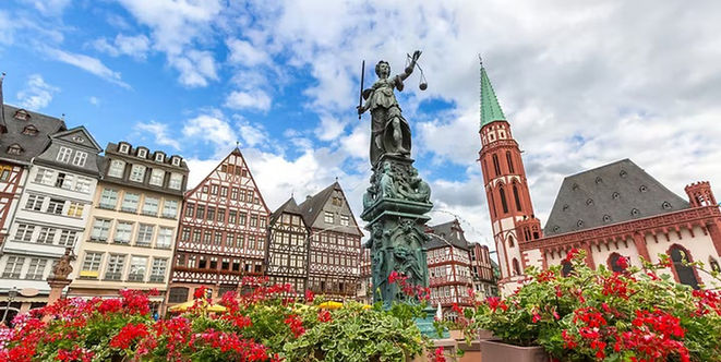 The Justice Fountain surrounded by half-timbered buildings on Romerberg Square in Frankfurt, Germany.
