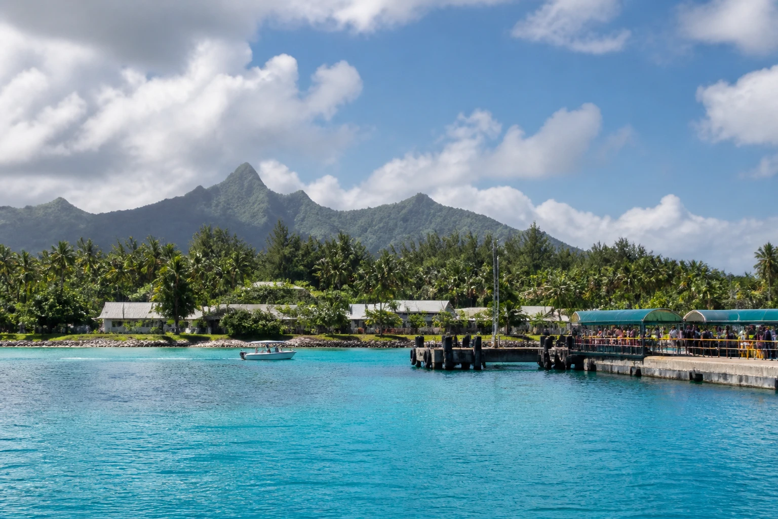Representative cruise port destination view: Aitutaki, Cook Islands; passenger waterfront and harbor water, not an exact landmark photograph.