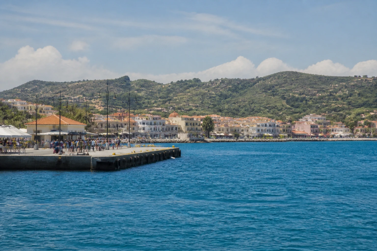 Representative cruise port destination view: Katakolon, Greece; passenger waterfront and harbor water, not an exact landmark photograph.