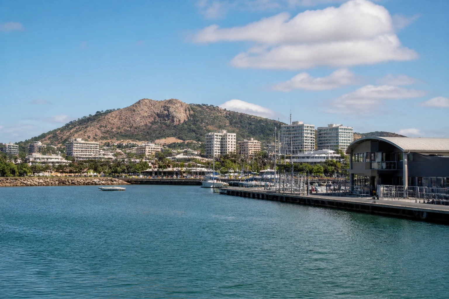 Representative cruise port destination view: Townsville, Australia; passenger waterfront and harbor water, not an exact landmark photograph.