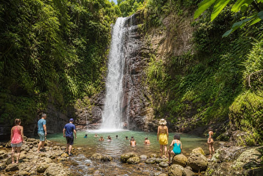 Visitors swimming beneath Toraille Waterfall near Soufrière, St. Lucia