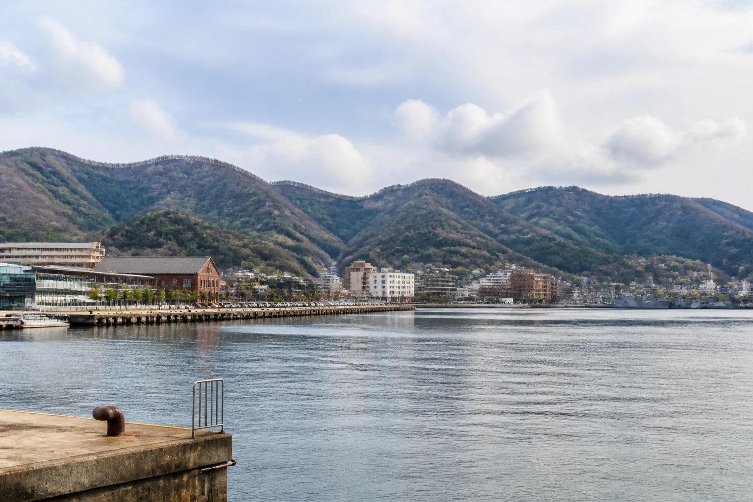 Representative cruise port destination view: Maizuru, Japan; passenger waterfront and harbor water, not an exact landmark photograph.