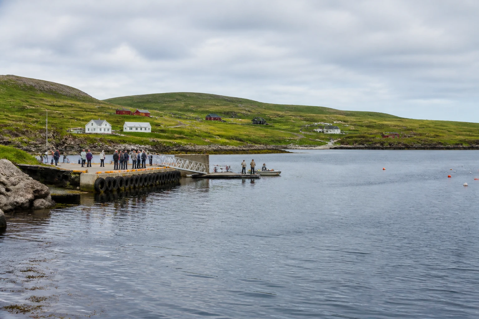 Representative cruise port destination view: L'Anse Aux Meadows, Canada; passenger waterfront and harbor water, not an exact landmark photograph.
