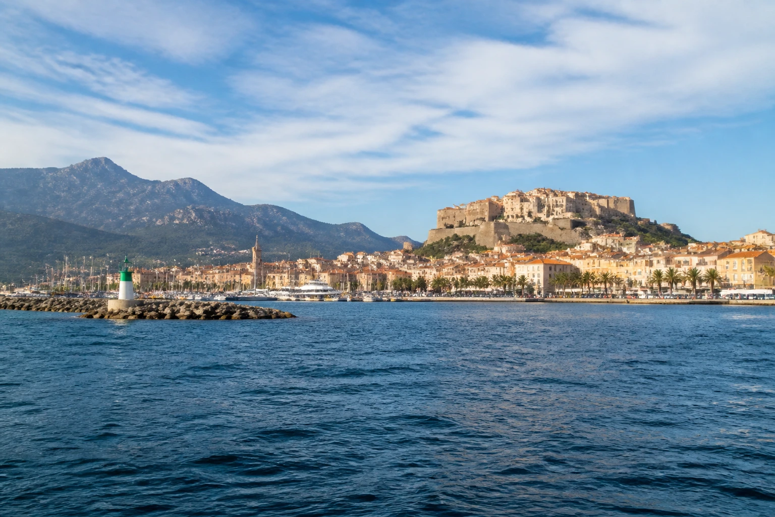Representative cruise port destination view: Calvi, France; passenger waterfront and harbor water, not an exact landmark photograph.