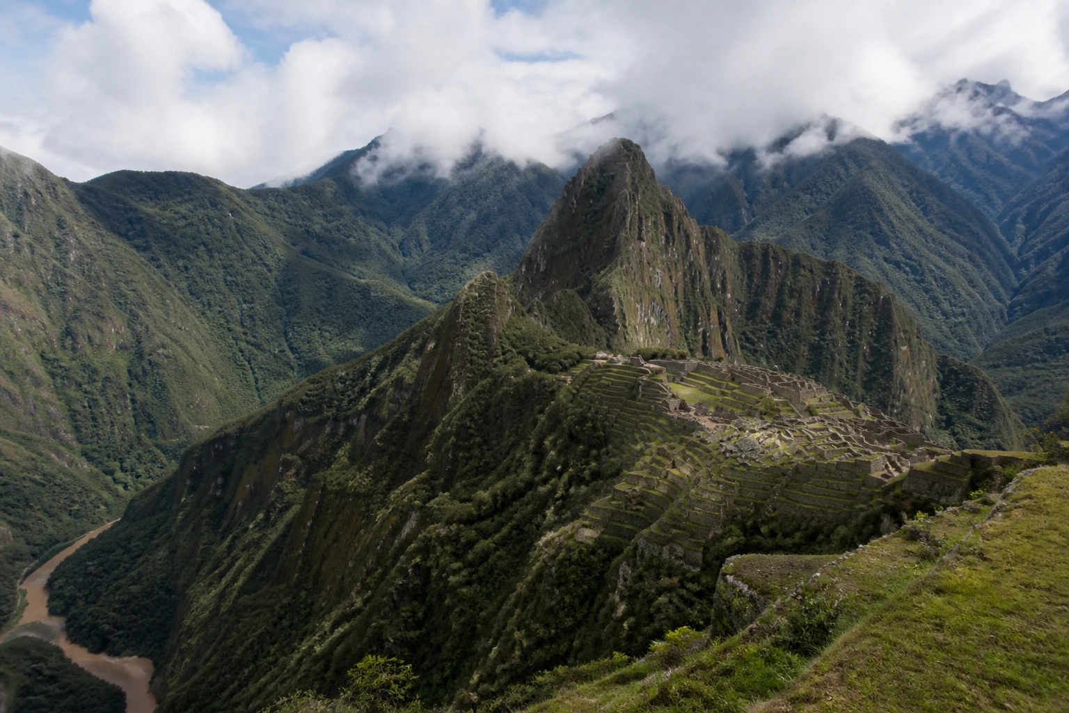 Representative mountain destination view: Cusco and Machu Picchu, Peru; mountain or canyon terrain and regional vegetation, not an exact landmark photograph.