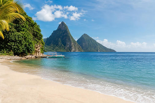Pale sand and clear blue water at Sugar Beach between the Pitons in St. Lucia