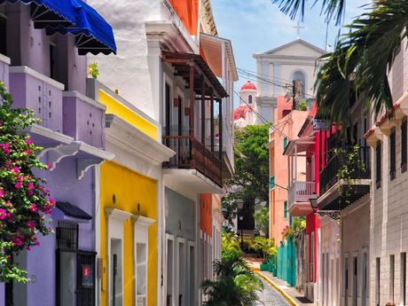 Colorful colonial homes and historic church viewed during an Old San Juan street tour