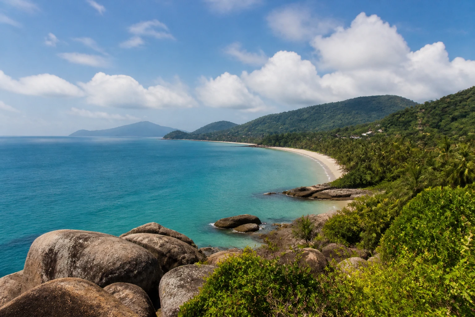 Representative island destination view: Koh Samui, Thailand; coastline and regional vegetation, not an exact landmark photograph.