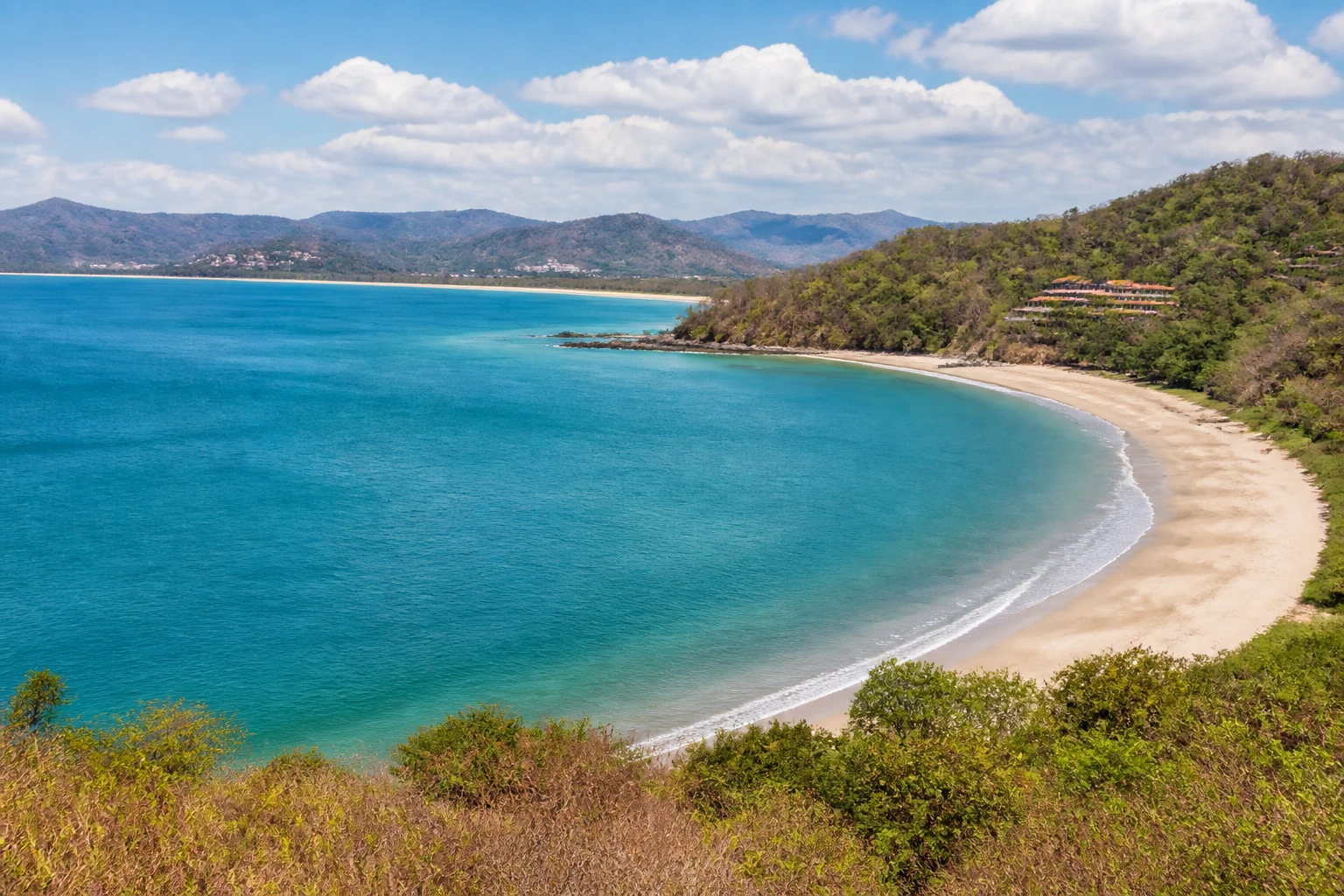 Representative coastal destination view: Guanacaste, Costa Rica; coastline and regional vegetation, not an exact landmark photograph.