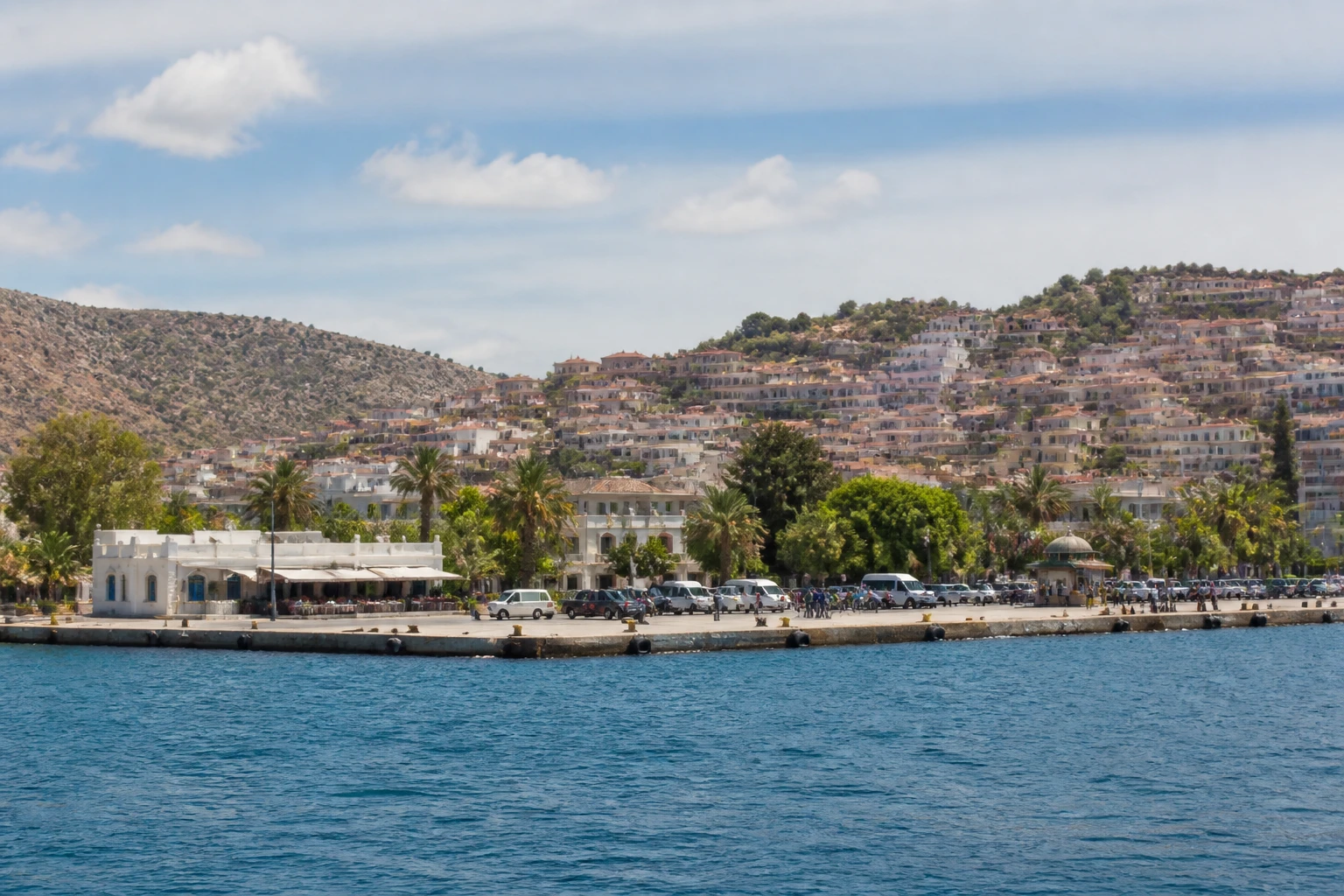 Representative cruise port destination view: Lesbos, Greece; passenger waterfront and harbor water, not an exact landmark photograph.