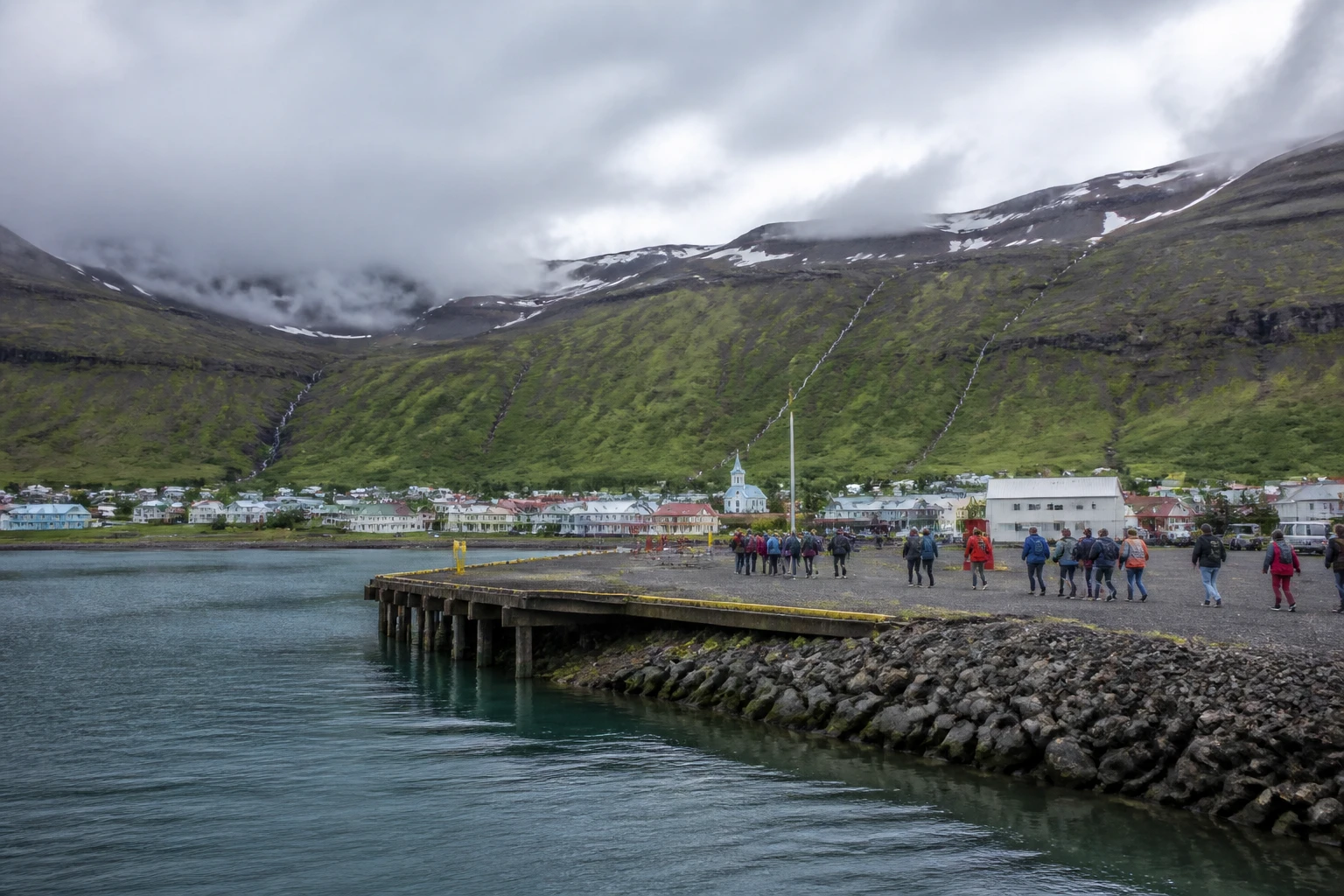 Representative cruise port destination view: Seydisfjordur, Iceland; passenger waterfront and harbor water, not an exact landmark photograph.