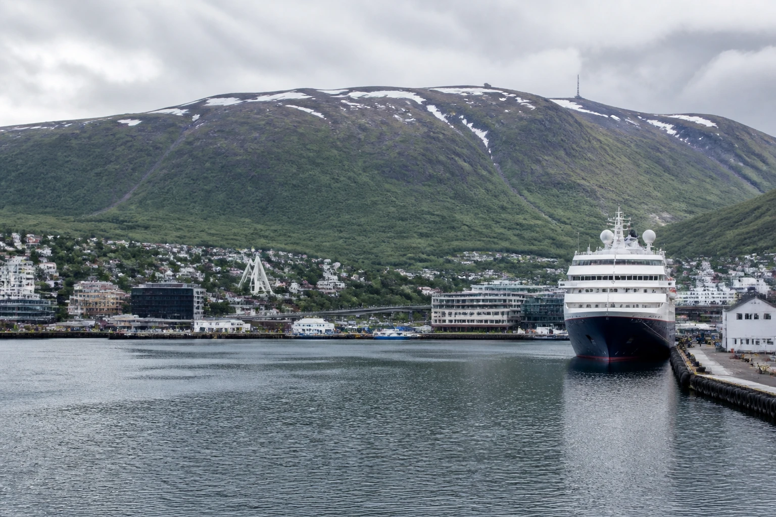 Representative cruise port destination view: Tromsø, Norway; passenger waterfront and harbor water, not an exact landmark photograph.