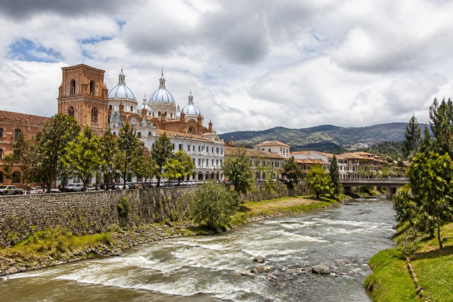 Representative historic city destination view: Cuenca, Ecuador; heritage-scale streetscape and regional architecture, not an exact landmark photograph.