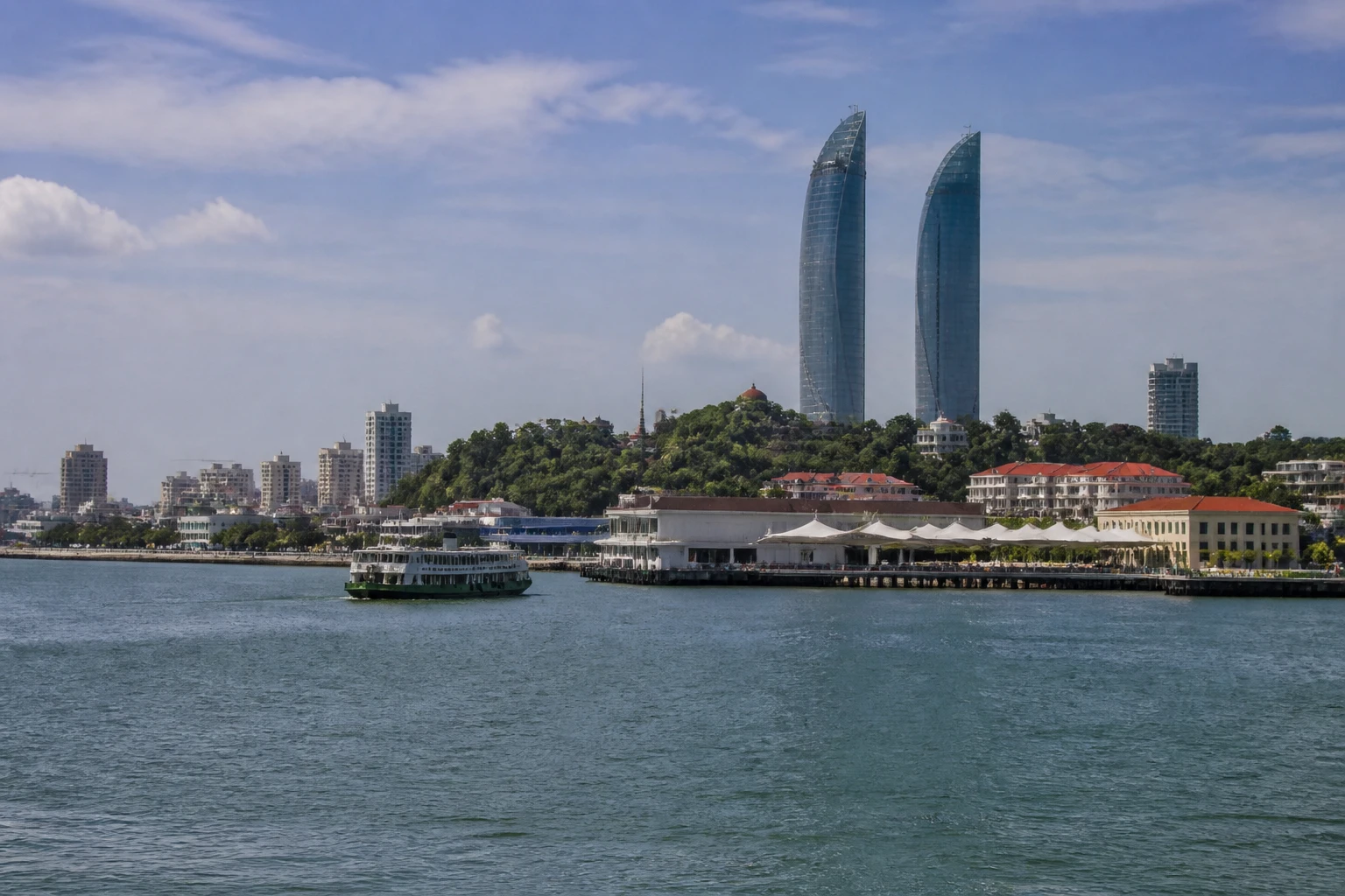 Representative cruise port destination view: Xiamen, China; passenger waterfront and harbor water, not an exact landmark photograph.