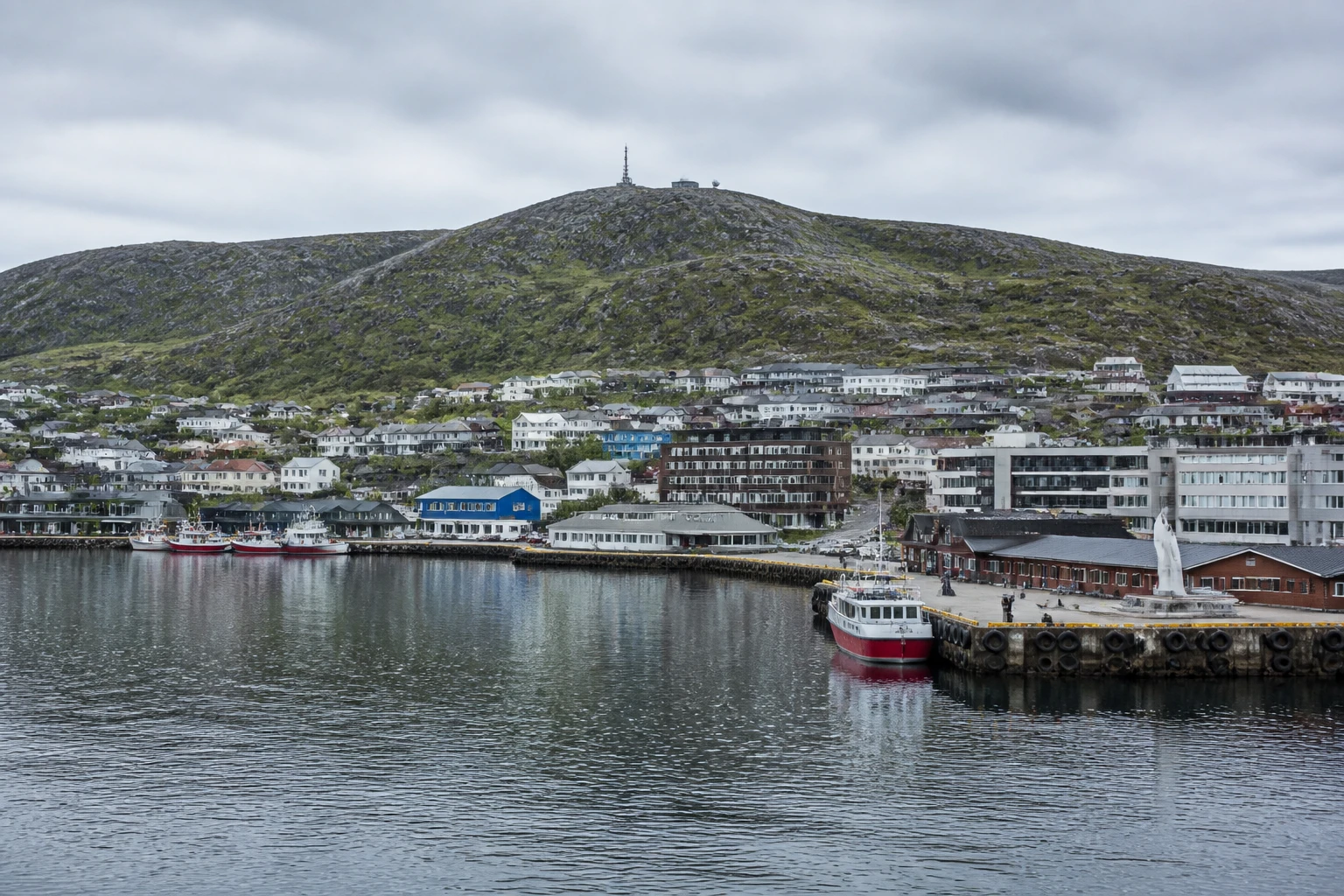 Representative cruise port destination view: Hammerfest, Norway; passenger waterfront and harbor water, not an exact landmark photograph.