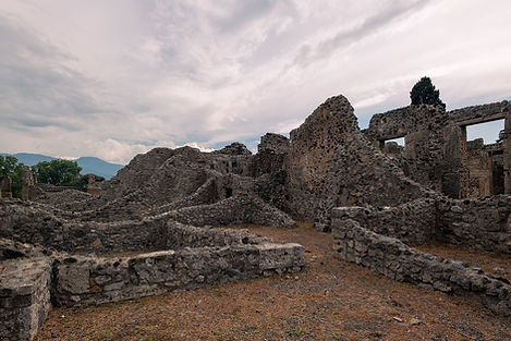 the archaeological ruins of Pompeii with Mount Vesuvius in Italy, a destination or experience featured on the The Best of Italy tour