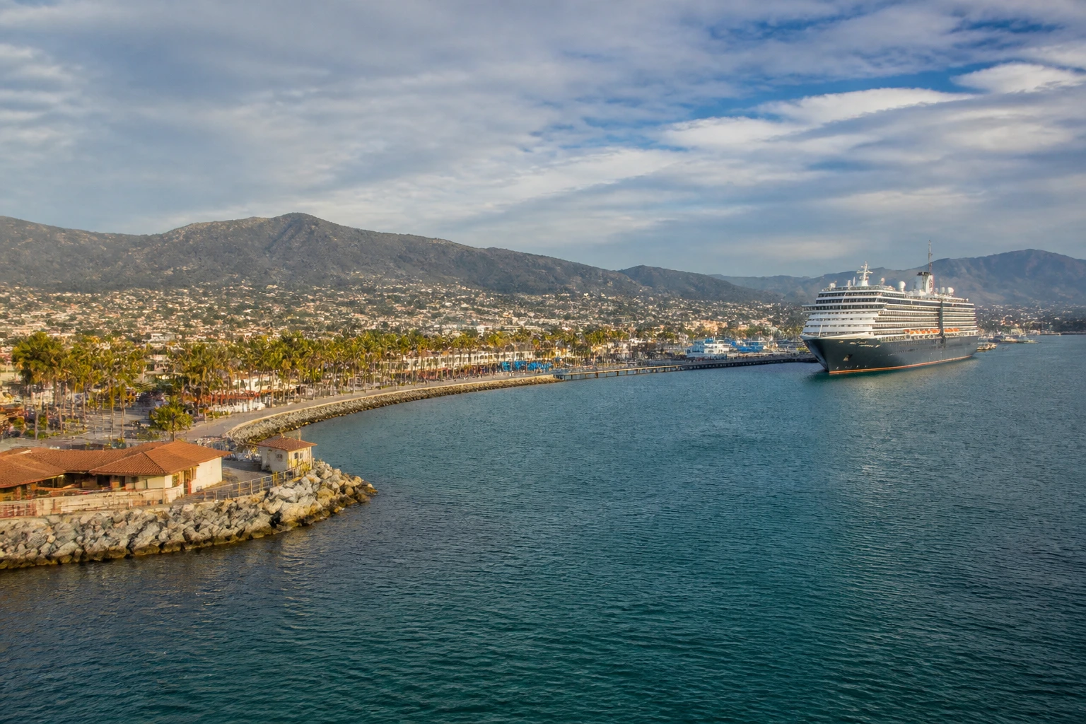 Representative cruise port destination view: Ensenada, Mexico; passenger waterfront and harbor water, not an exact landmark photograph.