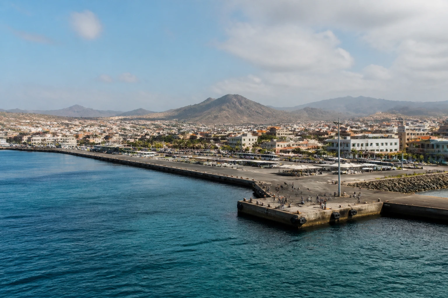 Representative cruise port destination view: Praia, Cape Verde; passenger waterfront and harbor water, not an exact landmark photograph.