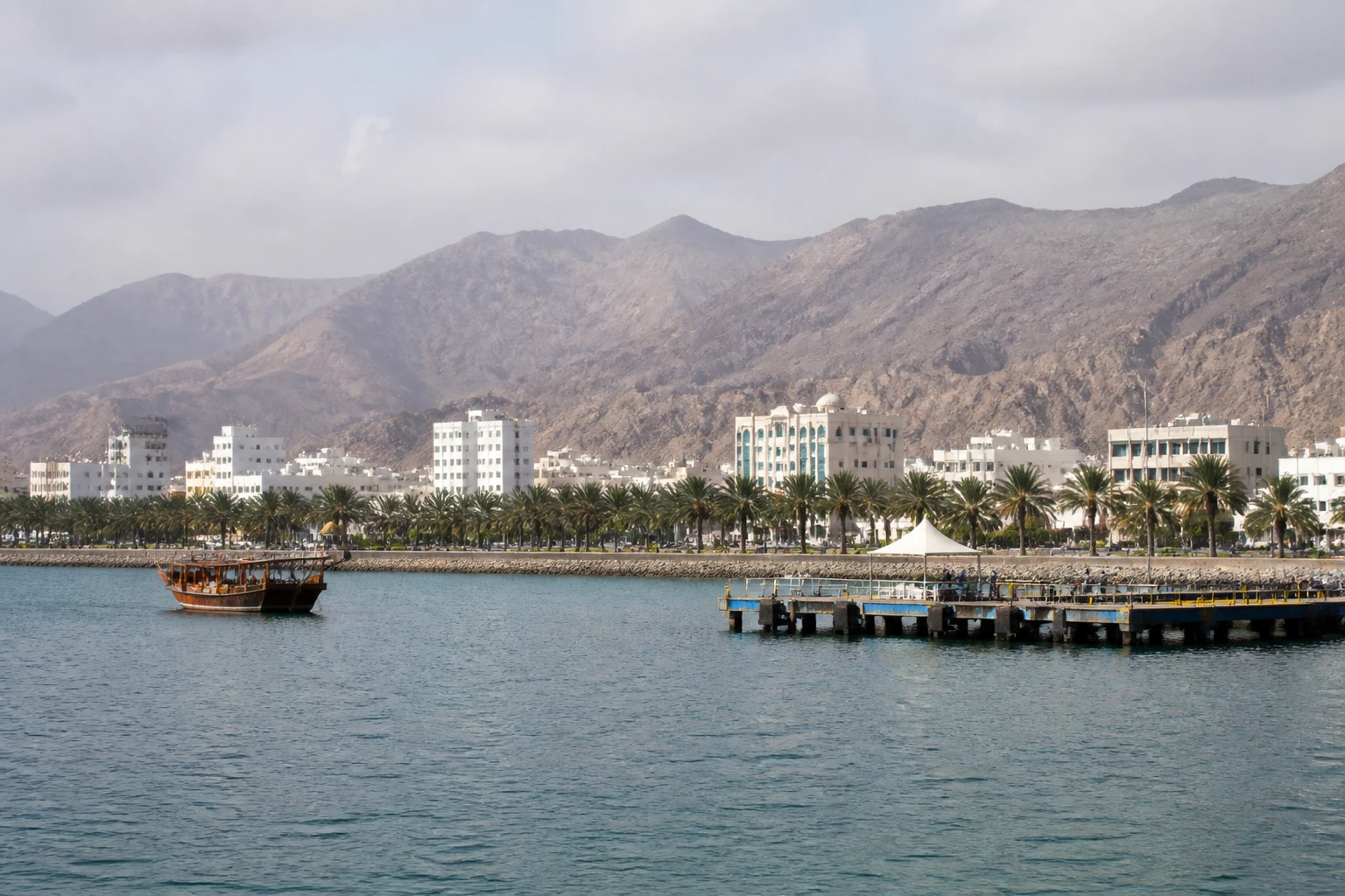 Representative cruise port destination view: Salalah, Oman; passenger waterfront and harbor water, not an exact landmark photograph.