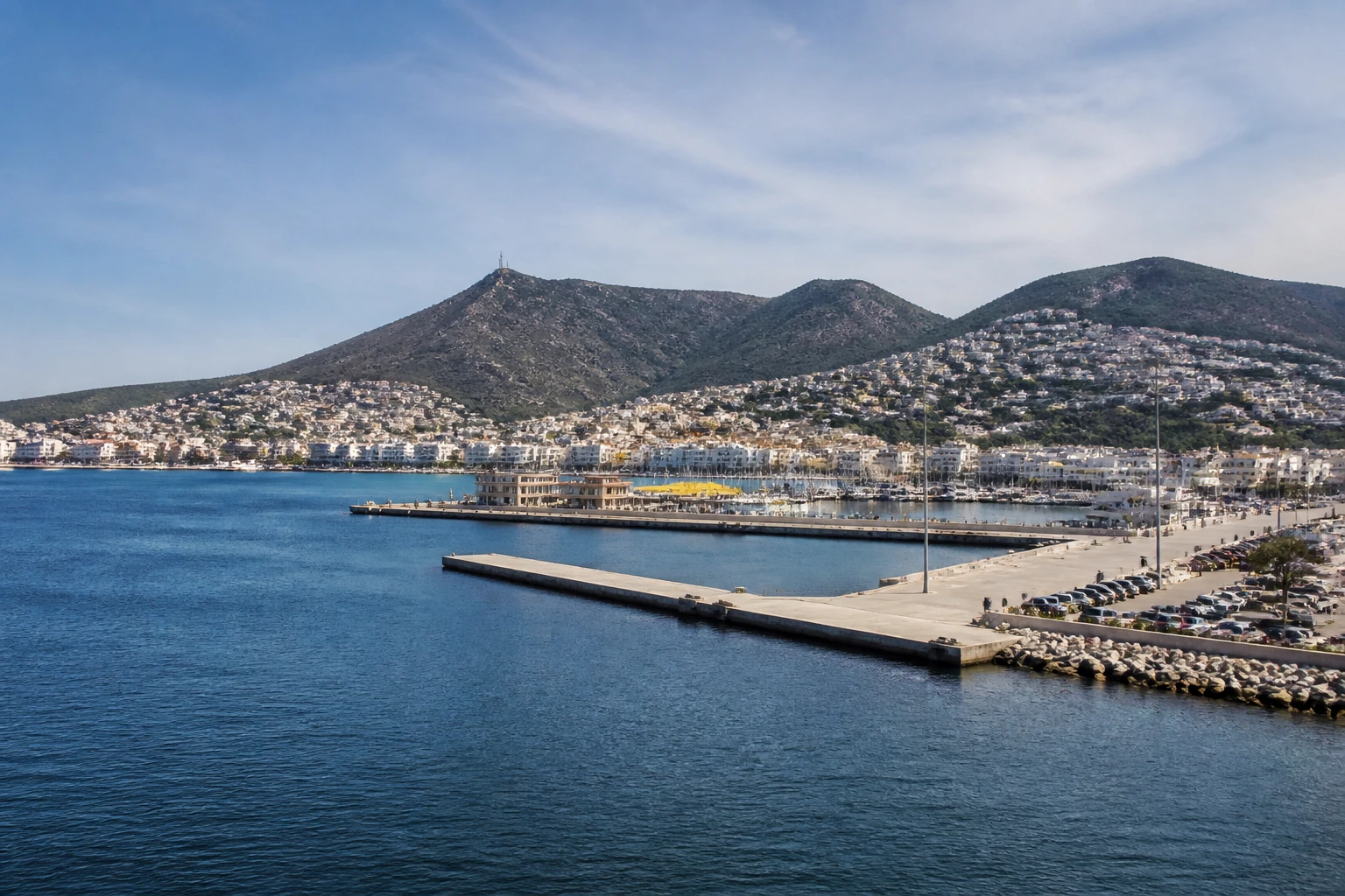 Representative cruise port destination view: Port Roses, Spain; passenger waterfront and harbor water, not an exact landmark photograph.