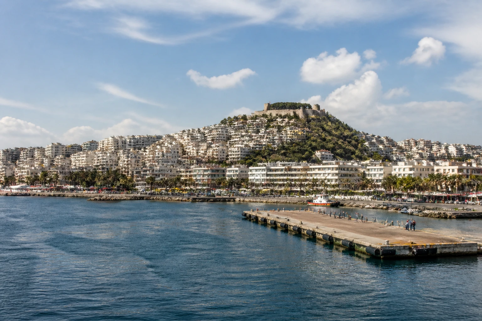 Representative cruise port destination view: Kuşadası, Turkiye; passenger waterfront and harbor water, not an exact landmark photograph.