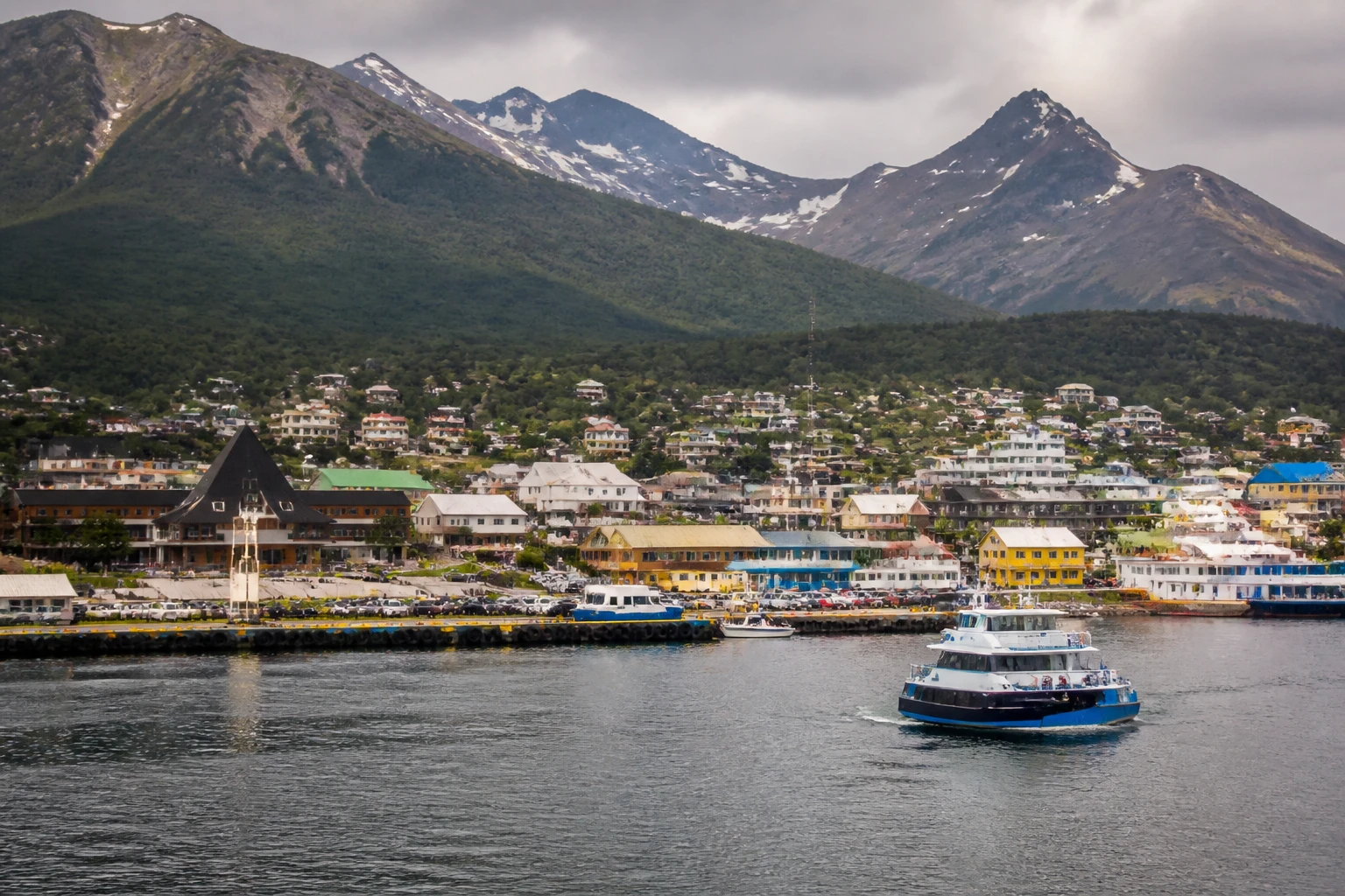 Representative cruise port destination view: Ushuaia, Argentina; passenger waterfront and harbor water, not an exact landmark photograph.