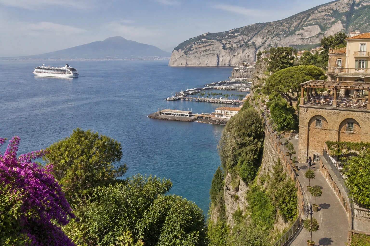 Representative coastal destination view: Sorrento, Italy; coastline and regional vegetation, not an exact landmark photograph.
