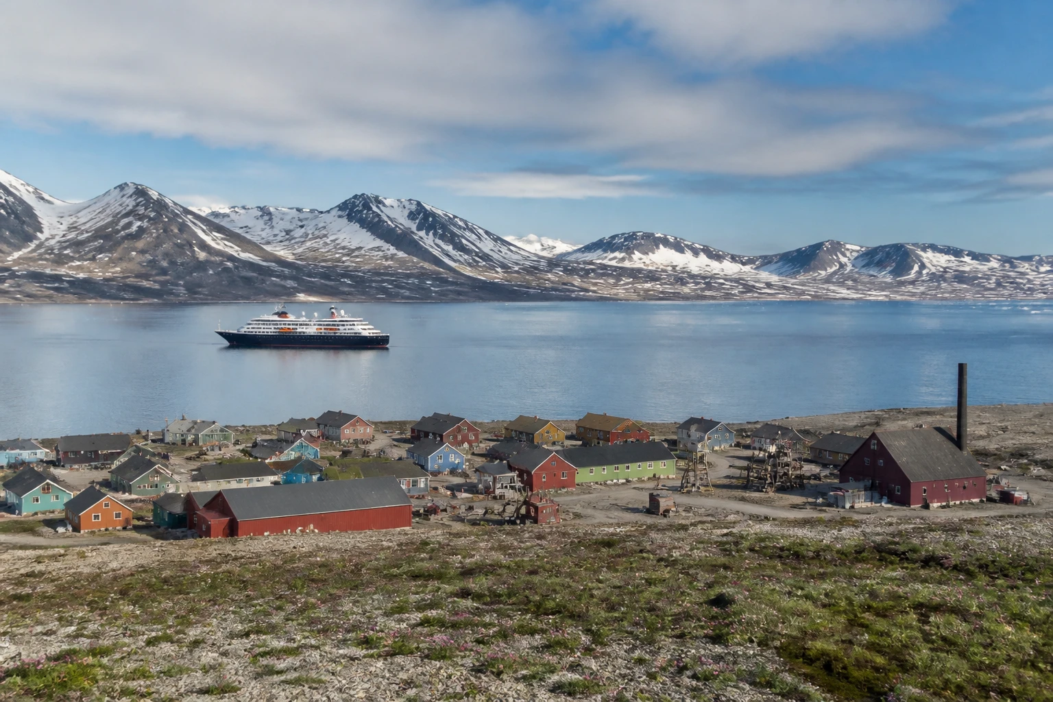 Representative arctic destination view: Svalbard, Norway; Arctic terrain and seasonally plausible light, not an exact landmark photograph.