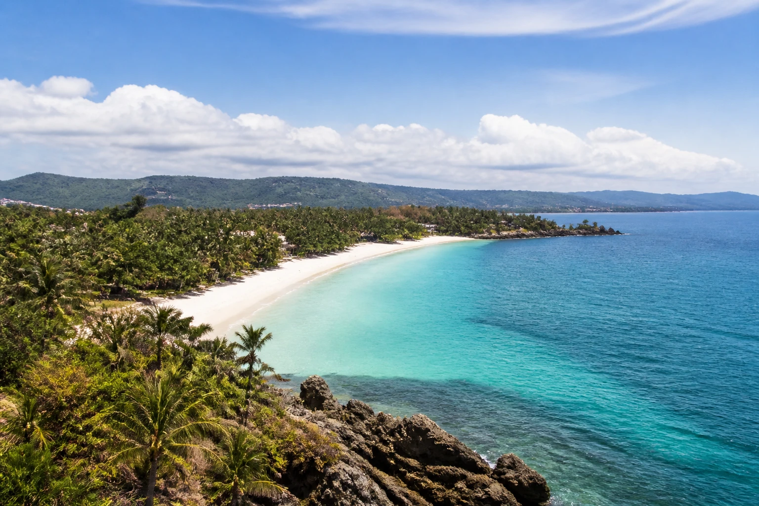 Representative island destination view: Boracay, Philippines; coastline and regional vegetation, not an exact landmark photograph.