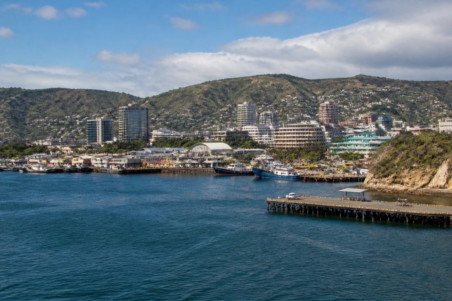 Representative cruise port destination view: Port Moresby, Papua New Guinea; passenger waterfront and harbor water, not an exact landmark photograph.