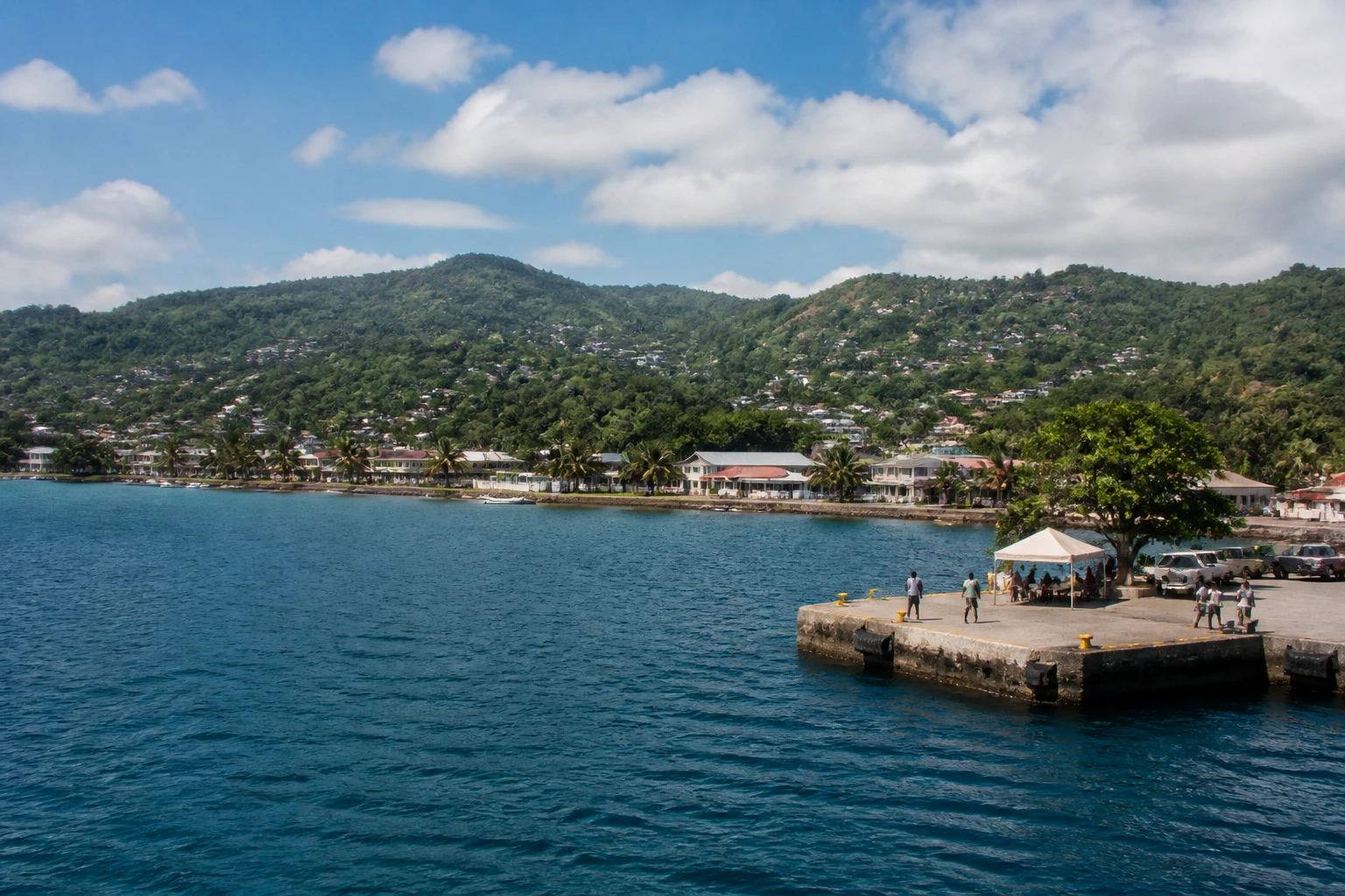 Representative cruise port destination view: Luganville, Vanuatu; passenger waterfront and harbor water, not an exact landmark photograph.