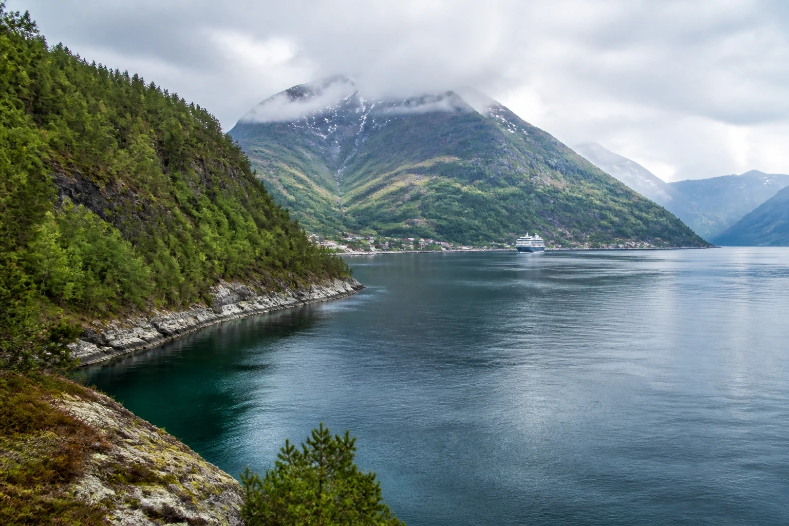 Representative coastal destination view: Flam, Norway; coastline and regional vegetation, not an exact landmark photograph.